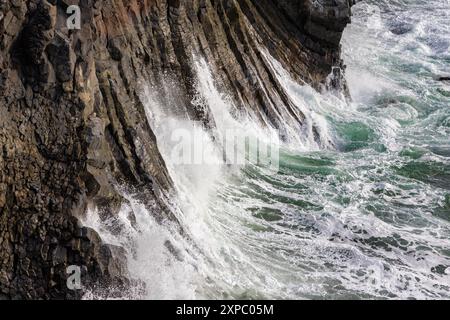 Basaltsäulen und die zerklüftete Küste von Arnarstapi auf der Snaefellsnes-Halbinsel im Westen Islands. Nahaufnahme der abstürzenden Wellen entlang der Stockfoto