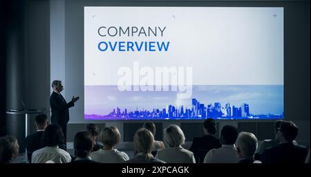 Firmenveranstaltung: Männlicher Chefmanager aus Kaukasien präsentiert Kollegen oder Investoren im Konferenzraum des innovativen Startup Office. Mann, Der Über Datenanalyse, Gewinne, Marktforschung Spricht. Stockfoto