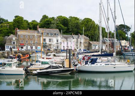 Am frühen Morgen mit wenigen Leuten. Boote und Segelyachten liegen im Innenhafen von Padstow. Cornwall England Vereinigtes Königreich Stockfoto