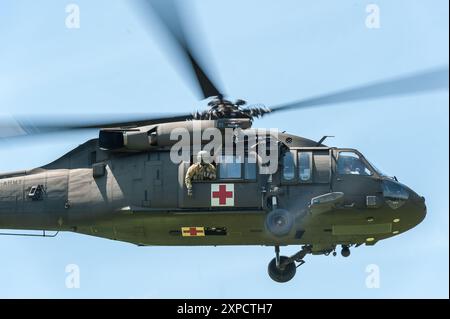 Medizinisches Team der United States Army auf einem Sikorsky HH-60M MEDEVAC Black Hawk Hubschrauber, der mit einem verletzten Fallschirmjäger in der Dropzone während Leapf startet Stockfoto