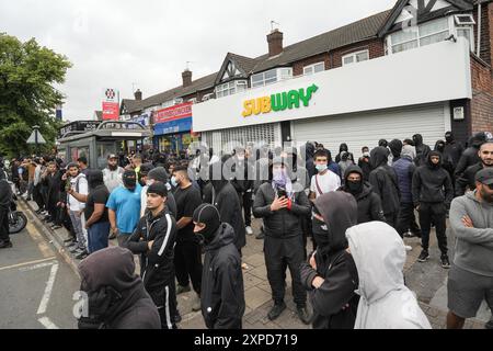 Bordesely Green, Birmingham 5. August 2024 - Hunderte von Menschen kamen heraus, um lokale Geschäfte und eine Moschee (Village Islamic Centre) zu schützen, nachdem Gerüchte über Mitglieder der EDL und andere Demonstranten in die Gegend kamen. Die Geschäfte wurden geschlossen und ein lokales Krankenhaus schickte das Personal nach Hause, da zu erwarten war, dass Gewalt bedroht war. Aufgrund der Reaktion der Komunionen kamen jedoch keine Patrioten an und die friedlichen Proteste setzten sich durch. ENDE - Guthaben: Stop Press Media/Alamy Live News Stockfoto