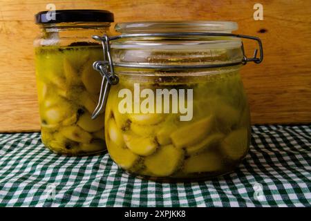 Zwei Gläser gekühltes Knoblauchconfit, in Olivenöl leicht gekochte Zehen. Kondenswasser, weil es gerade aus dem Kühlschrank kam. Stockfoto