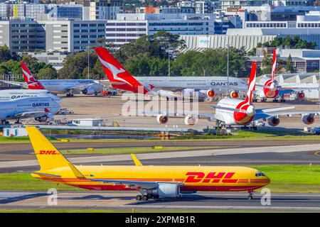 Qantas und DHL Jets auf dem Asphalt am Flughafen Sydney (Kingsford Smith) in Sydney, Australien. Stockfoto