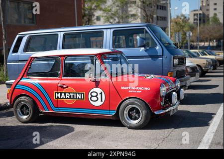 Ein roter Innocenti Mini mit Martini-Aufklebern. Daneben befindet sich ein blauer Volkswagen Transporter T3. Stockfoto