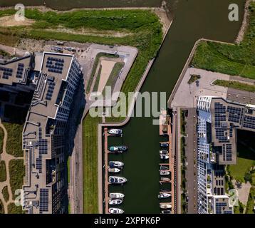 Blick von oben auf den Erholungshafen Noorderhaven mit zeitgenössischen, modernen Außenfassaden von Apartmenthäusern auf beiden Seiten und ein paar Booten Stockfoto