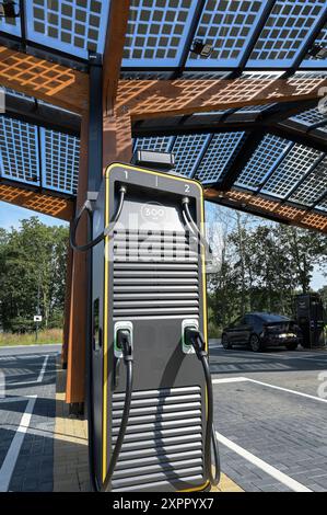 NIEDERLANDE, Fastned Schnellladestation für Elektrofahrzeuge an Tankstelle an der Autobahn, Solarzellen auf Dach / NIEDERLANDE, Fastned Stromladestation für Elektrofahrzeuge an Tankstelle an der Autobahn, Solarzellen auf Dach Stockfoto