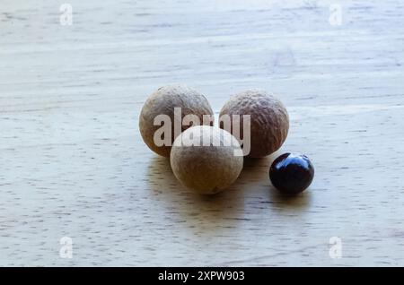 Drei Longan-Früchte auf einer Holzfläche Stockfoto