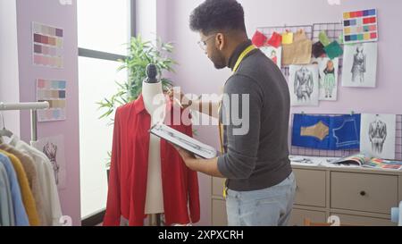 afroamerikaner in einem Schneiderladen, der eine Schaufensterpuppe misst, umgeben von Modeskizzen und Stoffproben. Stockfoto