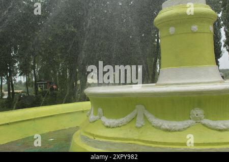 Wasser im Brunnen. Ein funktionierender Brunnen im Sommer. Wasser spritzt aus dem Brunnen. Stockfoto