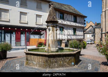 Frankreich, Region Nouvelle-Aquitaine, Donzenac, traditioneller Brunnen mit antiken Gebäuden in der Rue Haute Vialle Stockfoto