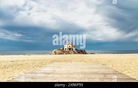 Kapelle in der Mitte des Strandes neben dem Wasser von Senhor da Pedra in Miramar, Portugal Stockfoto