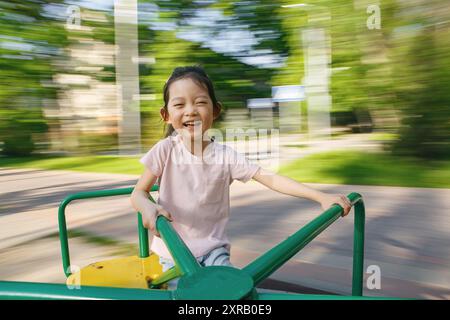 Kid Girl Lacht Beim Ritten Im Park Am Sonnigen Tag Stockfoto