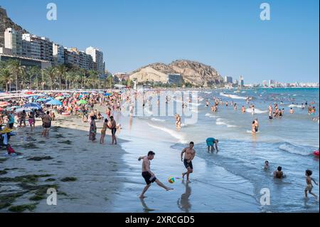 Alicante, Spanien. August 2024. Am Strand El Postiguet in Alicante schwimmen und spielen die Leute. Quelle: SOPA Images Limited/Alamy Live News Stockfoto