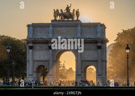 Paris, Frankreich - 08 05 2024: Olympische Spiele Paris 2024. Blick auf den Olympischen Kessel hinter dem Triumphbogen am Carrousel du Louvre bei Nacht Stockfoto