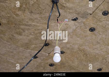 Dämmplatten aus Mineralwolle, die an der Decke verklebt wurden. Stockfoto