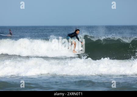 Deal, New Jersey - 10. August 2024: Surfer surfen auf den Resten des Hurrikans Debby in The Waters off Deal Stockfoto