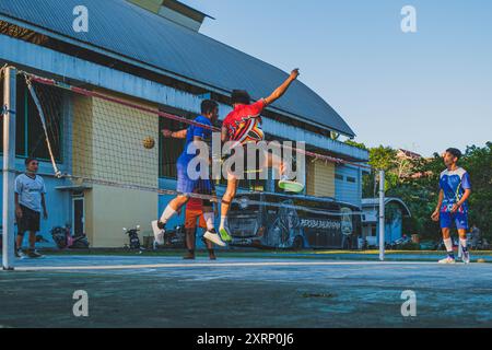 Balikpapan, Indonesien - 1. August 2024. Der mächtige Header des sepak Takraw-Spielers stieg über den Block des Gegners Stockfoto