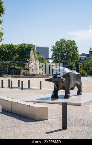 Nîmes, Gard, Frankreich - 08 04 2024 : vertikale Ansicht der Esplanade Charles de Gaulle mit Bronze-Stier-Skulptur von Djoti Bjalava und Pradier-Brunnen Stockfoto