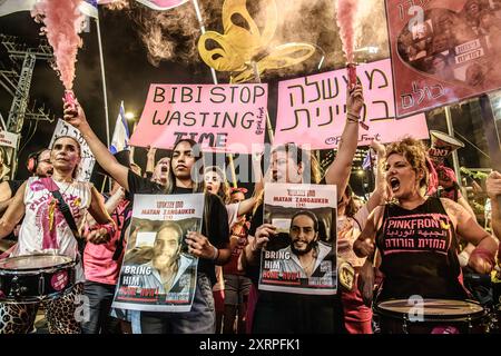 Tel Aviv, Israel. August 2024. Natali Zangauker, Schwester der israelischen Geisel Matan Zangauker, und ihr Cousin halten während der Kundgebung Plakate mit Matanís-Foto. Tausende Israelis demonstrierten mit den Familien der Geiseln gegen Premierminister Benjamin Netanjahu und forderten einen sofortigen Geiselvertrag und Waffenstillstand - während Israel auf den Angriff der Iraner und der Hisbollah wartet. Quelle: SOPA Images Limited/Alamy Live News Stockfoto