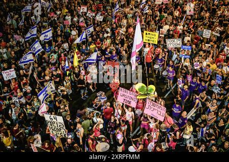 Tel Aviv, Israel. August 2024. Die Demonstranten schwenken die israelischen Flaggen und halten Plakate während der Kundgebung. Tausende Israelis demonstrierten mit den Familien der Geiseln gegen Premierminister Benjamin Netanjahu und forderten einen sofortigen Geiselvertrag und Waffenstillstand - während Israel auf den Angriff der Iraner und der Hisbollah wartet. Quelle: SOPA Images Limited/Alamy Live News Stockfoto