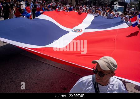 New York, Usa. August 2024. Teilnehmer mit Flagge der Dominikanischen Republik marschieren auf der 6th Avenue zur Dominican Day Parade. Die National Dominican Day Parade feierte 42 Jahre Marsch auf der Sixth Avenue in Manhattan. Die Parade feiert dominikanische Kultur, Folklore und Traditionen. (Foto: Ron Adar/SOPA Images/SIPA USA) Credit: SIPA USA/Alamy Live News Stockfoto