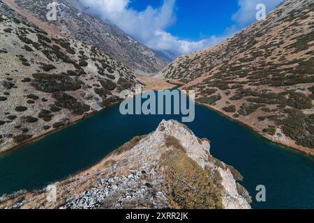 Panorama der Landschaft des Koksay-Sees mit blauem klarem Wasser in den Tien Shan-Bergen in Kasachstan im Herbst. Draufsicht von einer Drohne Stockfoto