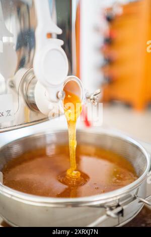 Dicker Viscouse Bienenhonig fließt in die Filtration Stockfoto