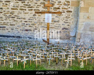 Die wunderschöne normannische Kirche St. Mary the Virgin im romanischen Stil befindet sich in Iffley Village, südlich von Oxford. Es wurde um 1160 n. Chr. von der Familie St. Remy erbaut. Das frühgotische Ostende wurde um 1230 verlängert, als auf der Südseite eine Zelle für die Anchoress (Einsiedler) Annora errichtet wurde. Wie von einem Gebäude dieser Antike erwartet, ist es in der Klasse I gelistet. Hier sehen wir auf dem Gelände ein Gedicht, das dem russischen Dissidenten Alexej Nawalny gewidmet ist, zusammen mit einem Schrein und Kreuzen für ukrainische Kriegstote. Stockfoto