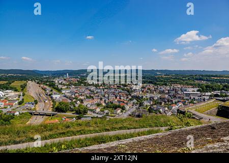 Panoramablick auf den Stadtrand von Givet von der Festung Charlemont, Eisenbahngleise, Gebäude, Bäume auf dem Land und Horizont im Hintergrund, Stockfoto