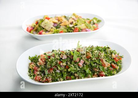 Ein Hauch von traditionellem arabischem Salat Fattoush und Tabbouleh auf weißem Hintergrund Stockfoto