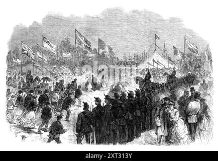 Eröffnung des Southwark Park, 1869. Öffentlicher Raum in Rotherhithe, Südosten Londons. Nach den Zahlen, die sich am Samstag versammelten, um die Eröffnung des Parks zu sehen, und wieder am Sonntag schien das Volk den Segen zu schätzen, der them...in verliehen worden war. trotz des schlechten Wetters schienen die meisten der versammelten Menschen Menschen der Arbeiterklassen zu sein, die zu Ehren des Anlasses ihre besten Kleider angezogen hatten... der 10. und 23. oder 4. administratives Bataillon von Surrey Rifle Volunteers, bestehend aus 400 bis 500 Mann, marschierten in die Parksperre ein und nahmen P Stockfoto