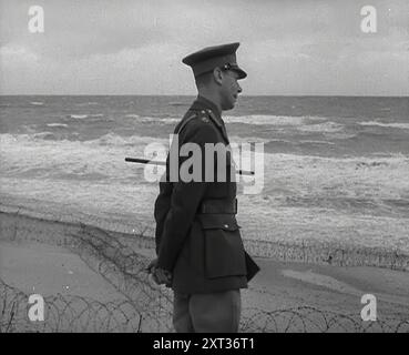 König Georg VI. Blickt auf das Meer, 1941. Zweiter Weltkrieg. "...die Operation Seelöwe musste wegen der Sturheit des Seelöwen aufgegeben werden". (Operation Sea Lion war der Codename der Nazis für ihre geplante Invasion in Großbritannien). Aus „Time to Remember – Operation Barbarossa“, 1941 (Rolle 1); Dokumentarfilm über Ereignisse von 1941, an der Ostfront und in Pearl Harbour. Stockfoto