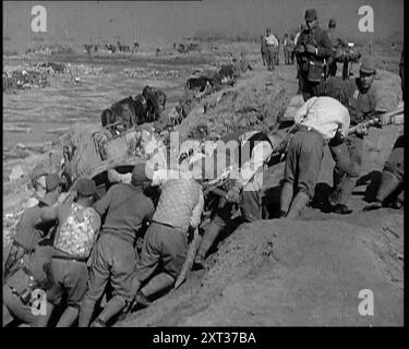 Männliche japanische Soldaten schleppen einen Wagen an einem Strand nahe Shanghai, 1937. „Als Japan aus seiner langen Abgeschiedenheit in die moderne Welt herauskam, suchten seine Führer, inspiriert von den alten Traditionen, die alle zum Sterben für die Ehre ihres Landes aufforderten, nach Expansion und Eroberung. Die westliche Welt hatte ihnen das Schlachtschiff, die Waffe und die Bombe gegeben. Jetzt suchten sie nach der Chance, sie zu nutzen. Japan hatte eine Armee, groß und hervorragend ausgebildet. Auch eine Marine, mächtig und ehrgeizig. Es ging nur darum, wann und wo. Ein Morgen im Jahr 1937, die Küste Chinas nahe Shanghai. Eine Armada von Kriegsschiffen Stockfoto