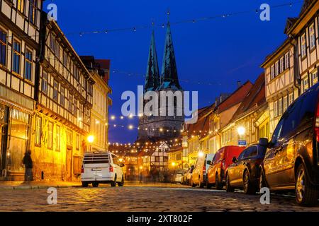 Charmante Quedlinburg Stadt Abendblick auf die Straße beleuchtet mit Weihnachtslichtern alte St. Nikolaus Kirche St. Nikolaus Kirche Hintergrund historische Hälfte Stockfoto