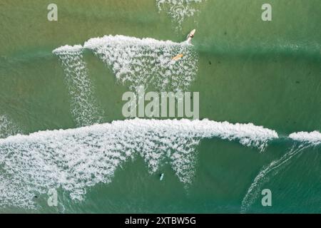Aus der Vogelperspektive eines einsamen Surfers, der in Port Roadknight an der Great Ocean Road in Victoria, Australien, eine Welle fängt. Stockfoto