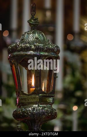 Nahaufnahme einer beleuchteten Laterne mit Kerzenflamme aus silbernem Glasmaterial Stockfoto