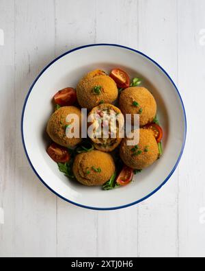 Spanische Tapa-Kroketten mit Bechamelsoße, gefüllt mit Tintenfisch und Kartoffeln. Tabelle mit Draufsicht Stockfoto