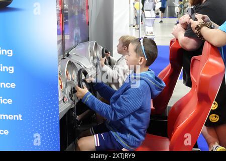 Farnborough, Hampshire, Großbritannien - Donnerstag, 15. August 2024 zwei Jugendliche zeigen ihren Eltern ihre Fahrkünste auf der BRITISCHEN AUTOMOBILAUSSTELLUNG 2024 im berühmten Flughafen Farnborough und Ausstellungszentrum Credit: Motofoto/Alamy Live News Stockfoto