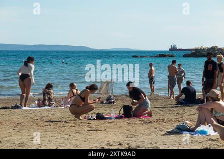 Sandiger, schöner Touristenstrand, der von Einheimischen und Touristen an einem heißen, sonnigen Tag mit blauem Himmel und Sonne genossen wird. Strand von Bacvice. Trennen. Kroatien. (138) Stockfoto