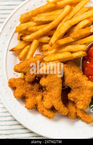 Gesunde Kinder Dinosaurier Chicken Nuggets mit Pommes und Ketchup Stockfoto