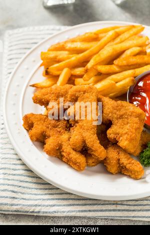 Gesunde Kinder Dinosaurier Chicken Nuggets mit Pommes und Ketchup Stockfoto