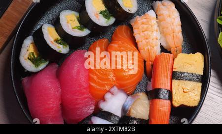 Verschiedene Sushi-Platten mit verschiedenen Arten von Nigiri, Maki-Brötchen und Stockfoto