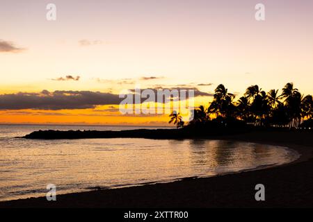 Wunderschöner hawaiianischer Sonnenuntergang über einer Strandbucht Stockfoto