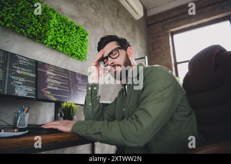 Porträt des professionellen Hackers junger Mann Kopfschmerzen Computer Schreibtisch Loft Innenraum Büro drinnen Stockfoto
