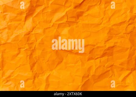 Die Draufsicht und der ganze Rahmen der zerknitterten oder zerknitterten orangefarbenen Papierhintergrundstruktur wird als zerknitterte orangefarbene Papierhintergrundstruktur in dekorativen Kunstwerken verwendet Stockfoto