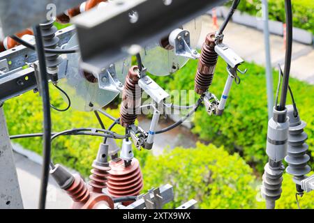 Hochspannungssicherungen am Hochspannungspol, aus-Lastschalter, dreiphasige Hochspannungssicherungen auf Stahlträgern Drahtverbindung auf Betonelektrik Stockfoto
