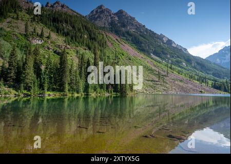 Kastanienbraune Glocken spiegeln sich am sonnigen Sommernachmittag unter dramatischer Sommerwolke im Maroon Lake. Stockfoto