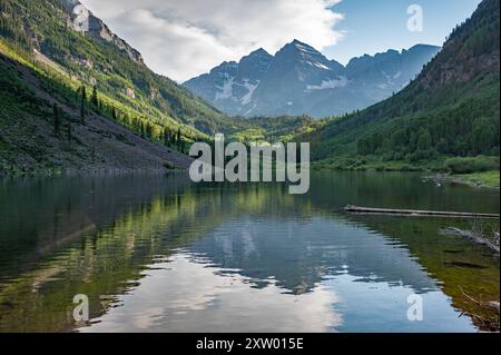 Kastanienbraune Glocken spiegeln sich am sonnigen Sommernachmittag unter dramatischer Sommerwolke im Maroon Lake. Stockfoto