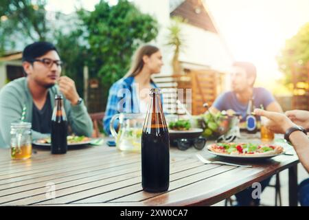 Mittagessen, Bier und Gruppe mit Essen, Outdoor und Treffen für Wiedersehen mit Freunden, Hinterhof und Essen. Haus, Hände und Teller Salat am Wochenende, Hof Stockfoto