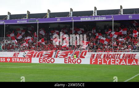 17. August 2024, Niedersachsen, Osnabrück: Fußball: DFB-Cup, VfL Osnabrück - SC Freiburg, 1. Runde im Stadion Bremer Brücke. Freiburgs Fans zeigen eine Choreografie. Foto: Friso Gentsch/dpa - WICHTIGER HINWEIS: Gemäß den Vorschriften der DFL Deutschen Fußball-Liga und des DFB Deutschen Fußball-Bundes ist es verboten, im Stadion und/oder im Spiel aufgenommene Fotografien in Form von sequenziellen Bildern und/oder videoähnlichen Fotoserien zu verwenden oder zu verwenden. Stockfoto